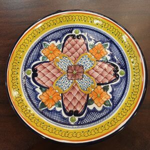 This authentic Mexican Talavera plate features hand-painted, vibrant floral